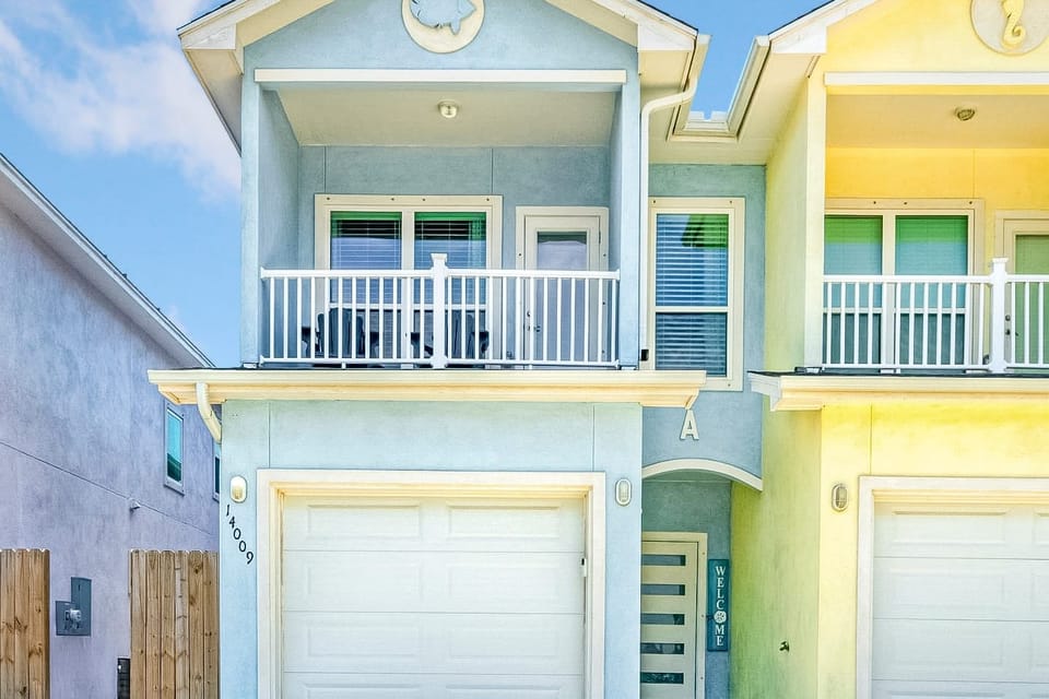 Beautiful two-story home with garage and inviting balcony.