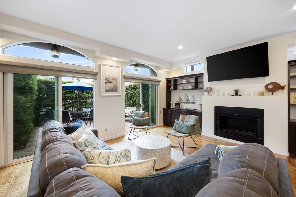 Cozy living room with a TV and seamless access to the balcony.