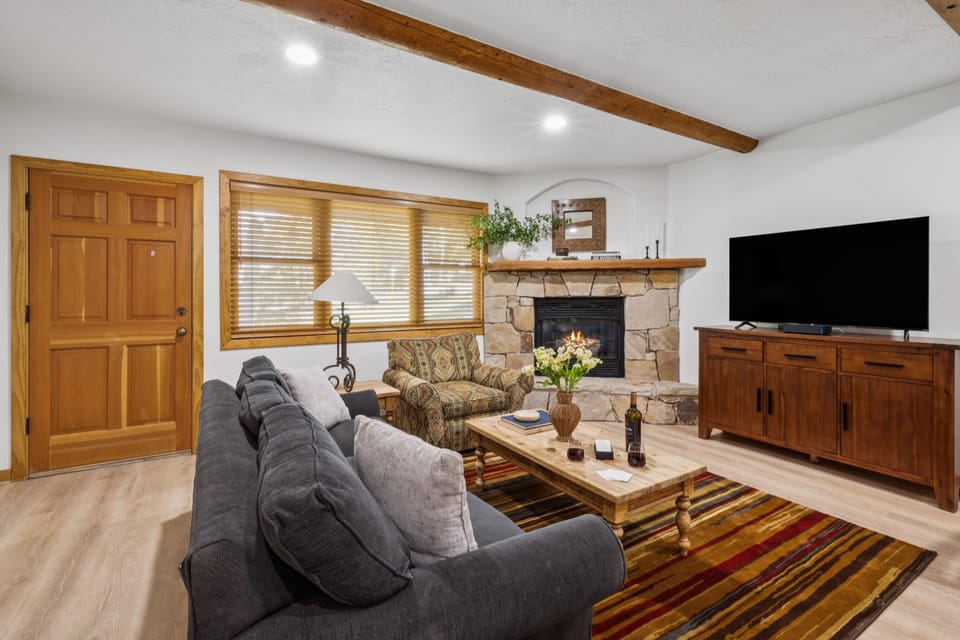 A warm and cozy living room with a fireplace and rustic decor.