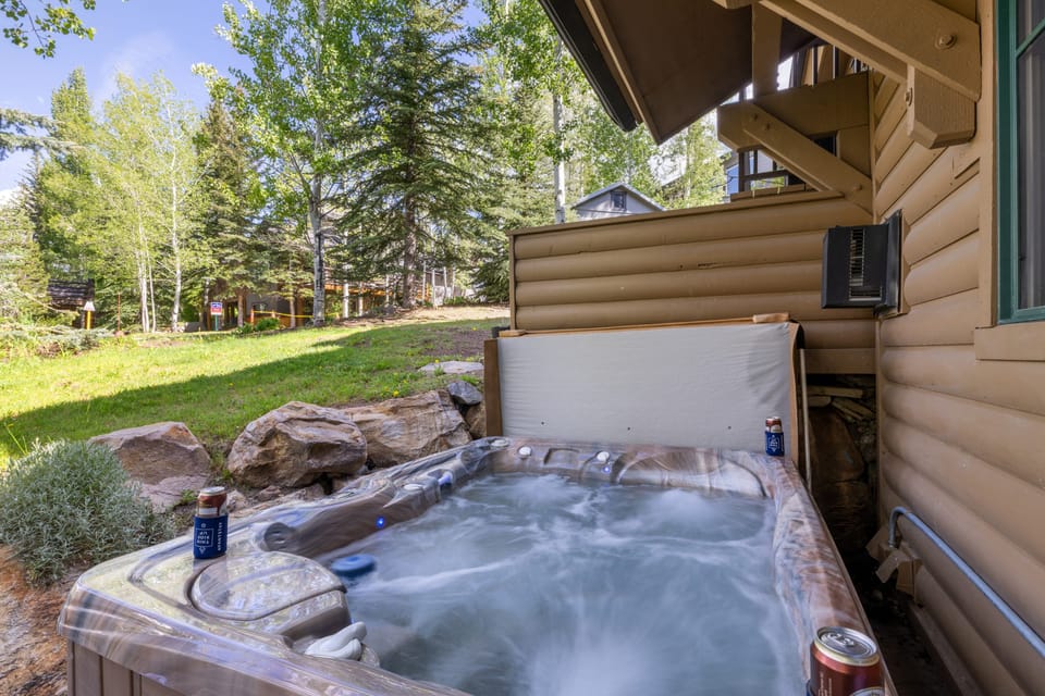View of the bubbling hot tub surrounded by greenery.