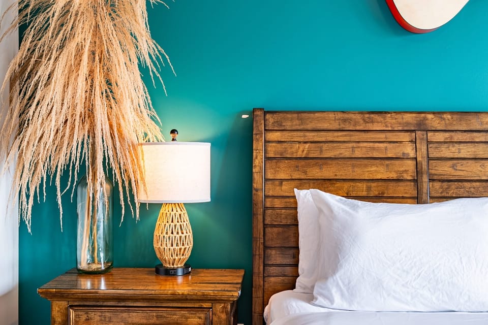 Stylish bedroom with bold teal accent wall.