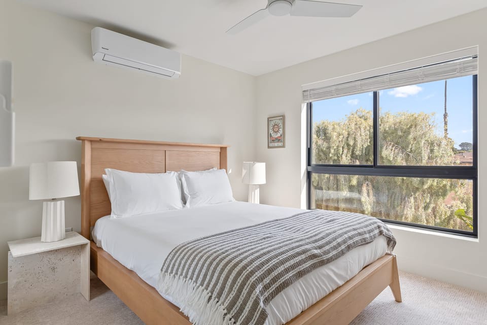 Bedroom 2 features a queen bed, TV and an ensuite bathroom.