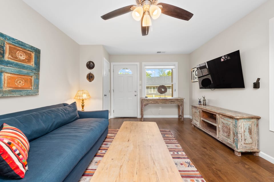 Living room features a sofa and TV. (Little Sycamore)
