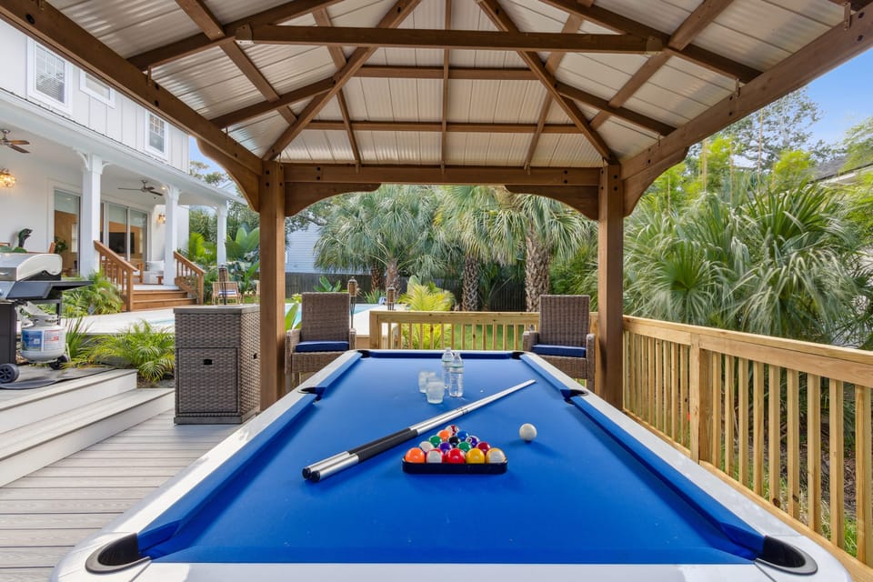 Outdoor entertainment with covered pool table.