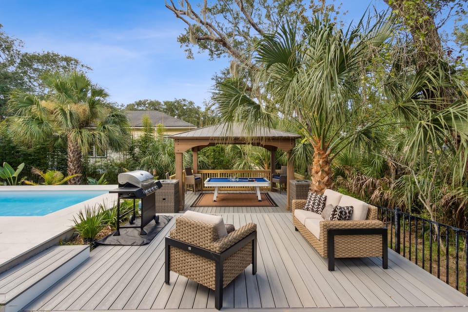 Covered porch with cozy outdoor seating.