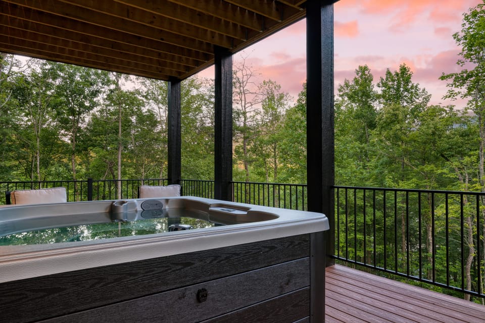 Covered hot tub with sunset mountain views.