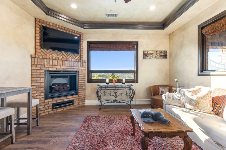 Living room with a full-size sleeper sofa, TV, and inviting fireplace for cozy evenings.