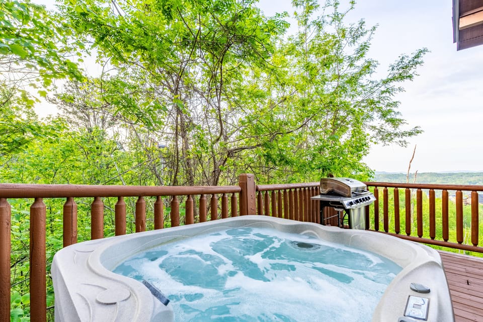 Fire up the grill while enjoying the private hot tub. (Hollow's Haven)