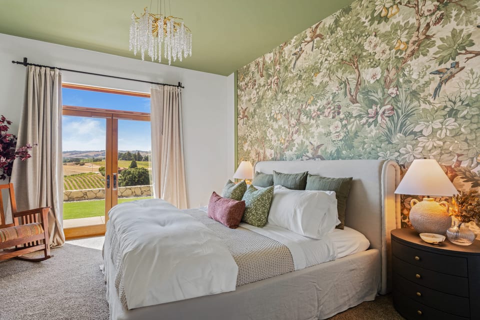 The primary bedroom features a king bed, a walk-in closet, an en-suite bath, access to an outside patio, and forced central air conditioning (heat/ac).