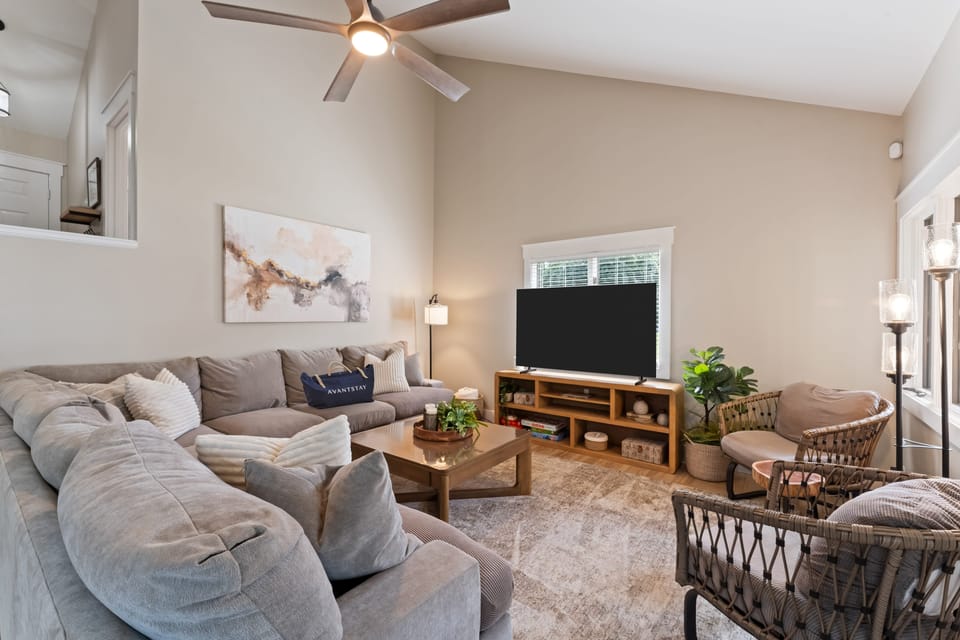 Cozy living room with plush sofa, TV, and a selection of board games for family fun.