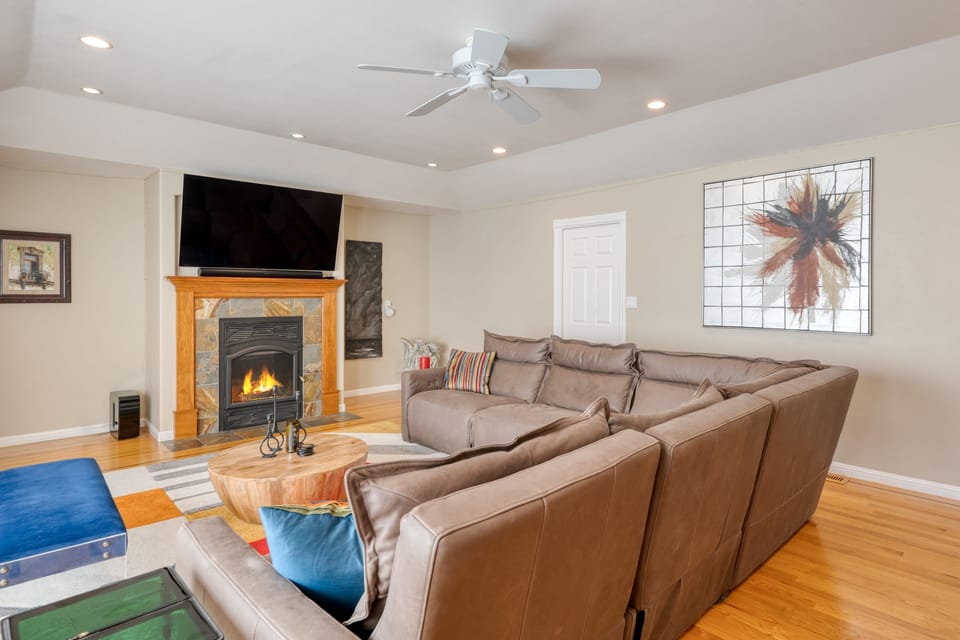 Gather and unwind—spacious living room with a cozy fireplace and plush seating for ultimate comfort.