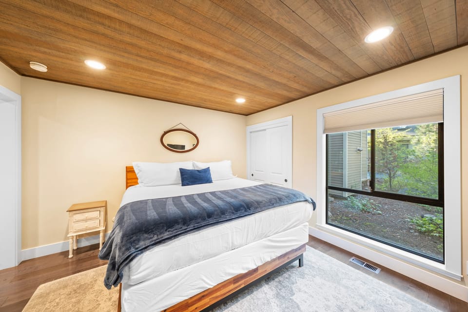The primary bedroom features a king bed, TV, and an ensuite bathroom.