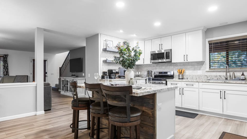 Kitchen with barstool seating and open layout.