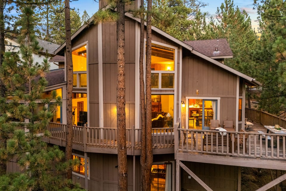 Tucked away in the pines, this cabin's warm glow and inviting decks are the perfect welcome to your getaway.