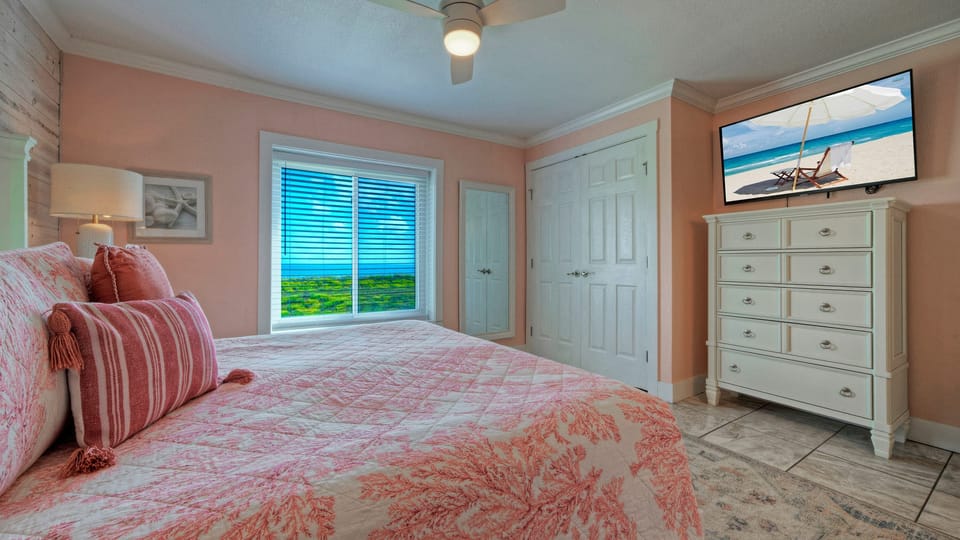 The primary bedroom features a king bed, TV, and an ensuite bathroom.