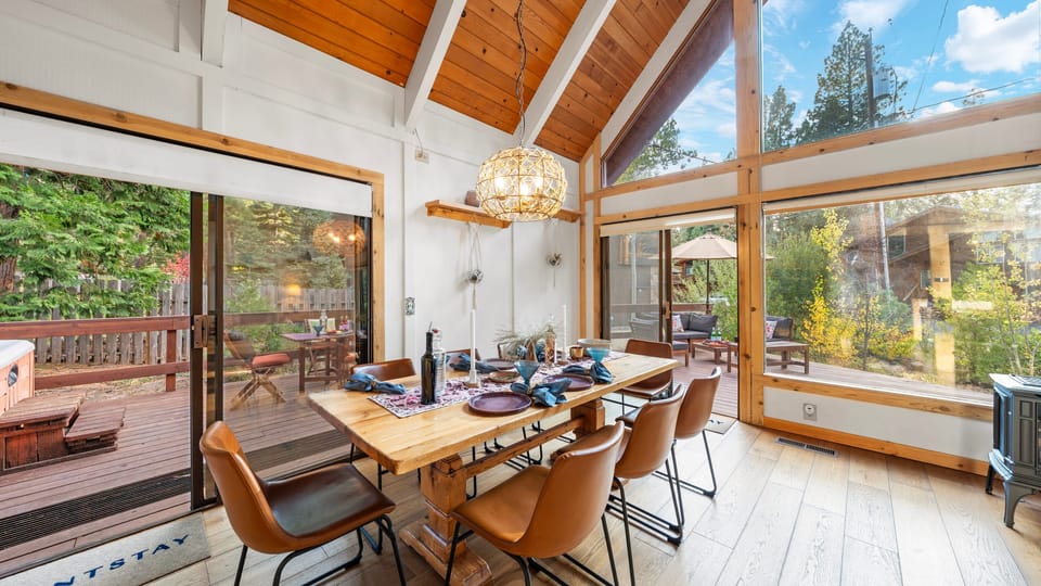 Spacious dining room with views of the surrounding forest.