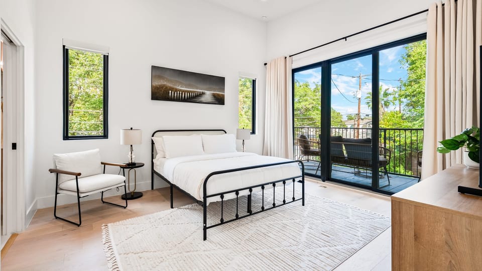 Spacious bedroom with outdoor views.