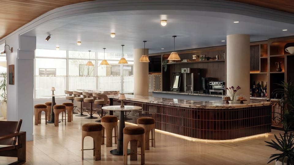 Stylish on-site lounge with cozy seating, artisan coffee, and a warm modern atmosphere perfect for slow mornings or evening cocktails.