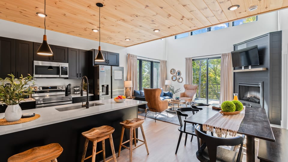 Open-concept area features seamless transitions from living to kitchen area.