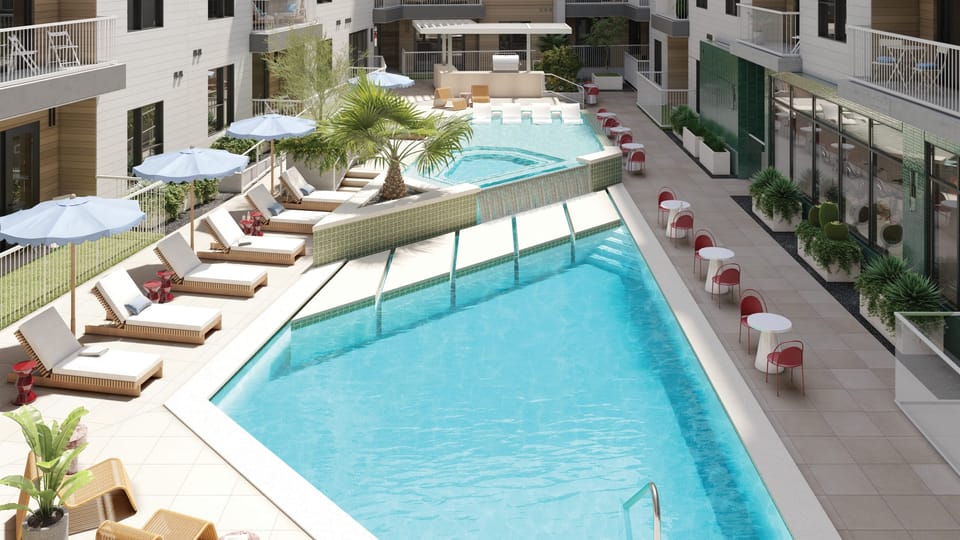 Resort pool with outdoor kitchen and poolside dining.