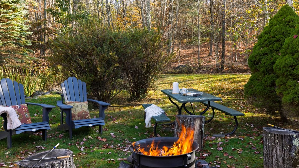 Expansive backyard featuring a sitting area with a fire pit.