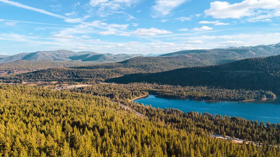 Aerial view of surrounding lakes and mountain terrain.
