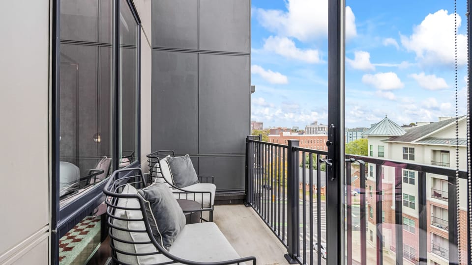 Balcony with seating and open city views.