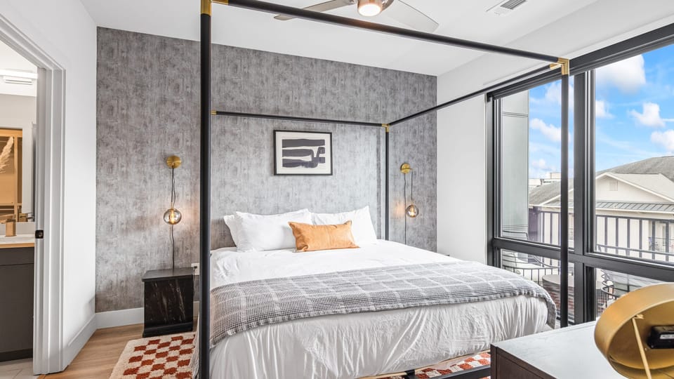 The primary bedroom features a king bed, TV, and an ensuite bathroom.