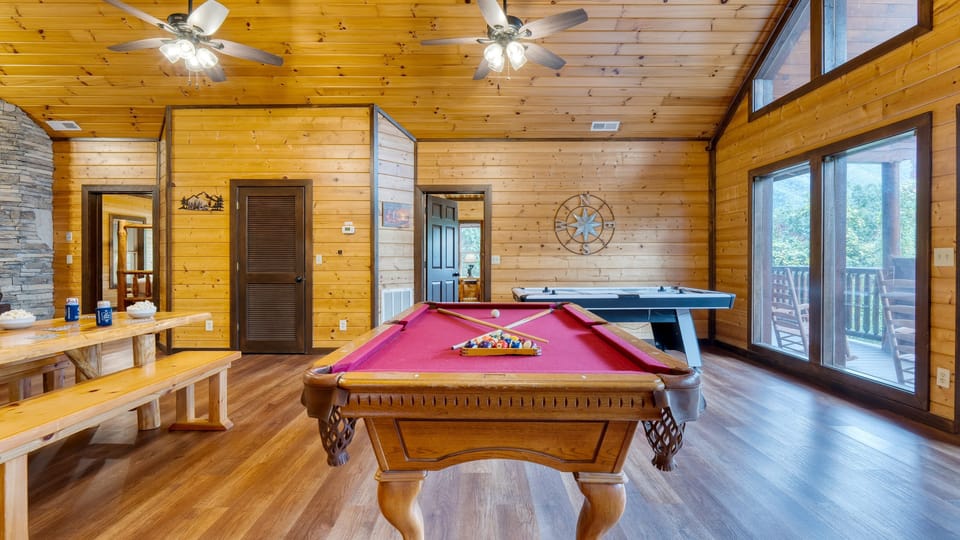 Game room with pool table, air hockey & arcade games.