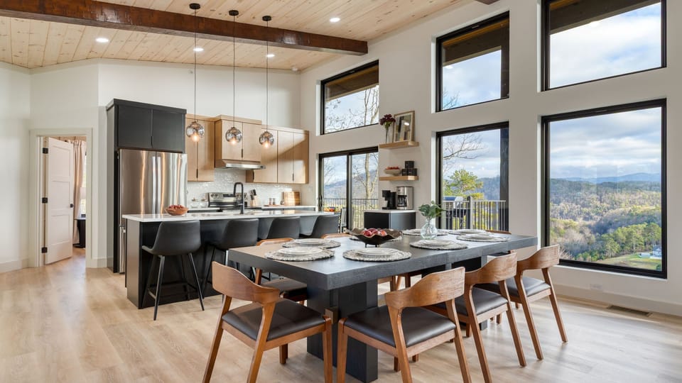 Modern kitchen and dining area with sleek finishes and expansive windows overlooking the Smoky Mountains.