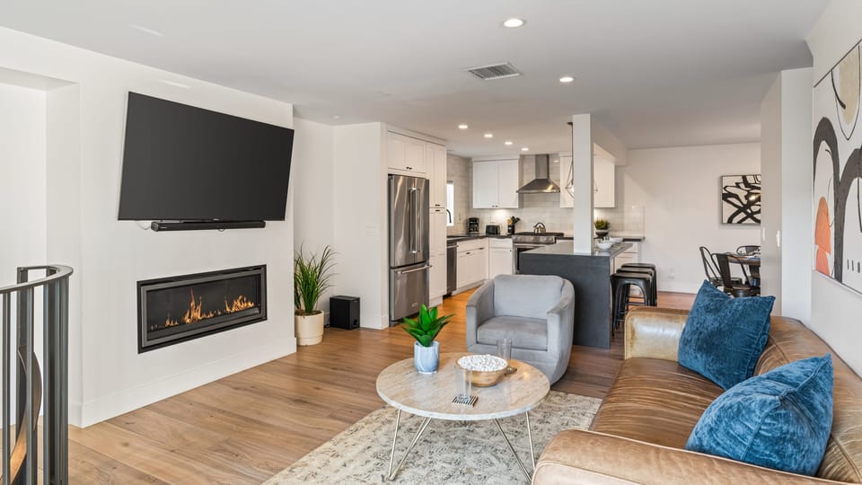 Modern living room with fireplace and cozy seating area.