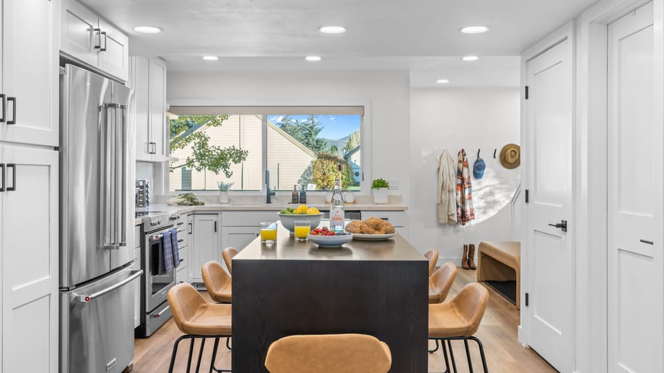 Open-concept kitchen and dining area with island seating.