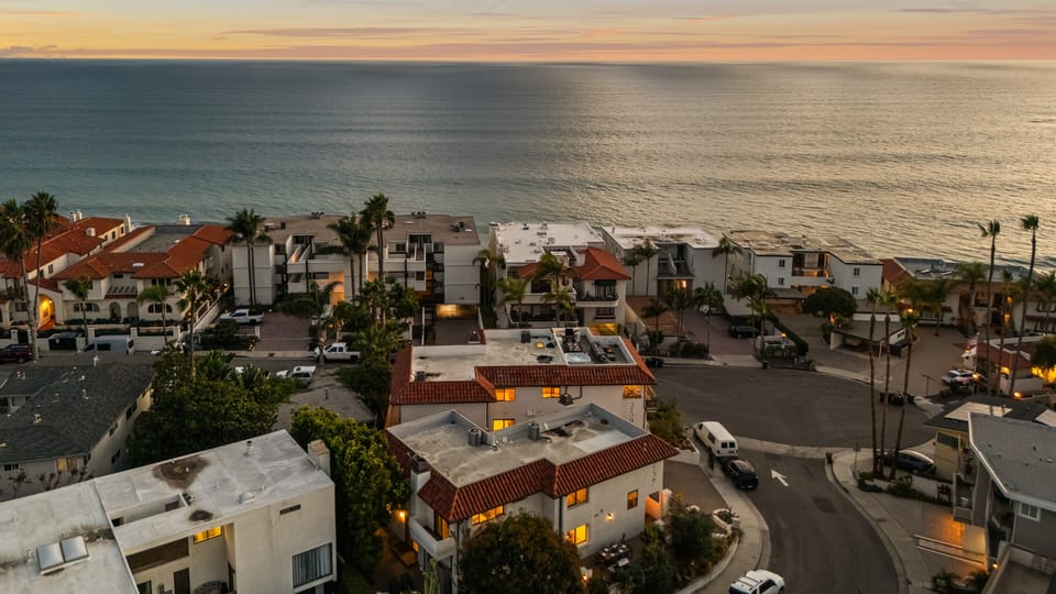 Aerial of coastline and home in a neighborhood.