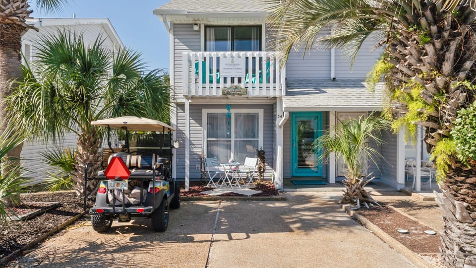 Front exterior of the house with golf cart.