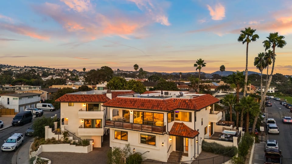Stunning Newport Beach villa with coastal views, warm sunset skies, and inviting indoor-outdoor living.