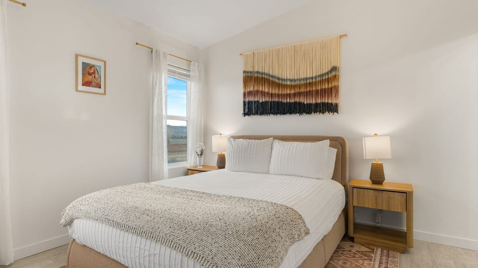 Bedroom with a neutral bedspread.
