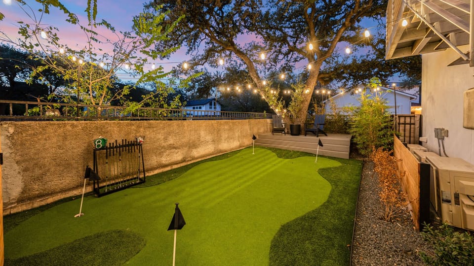 Enjoy the putting green under glowing string lights for a relaxing evening activity.