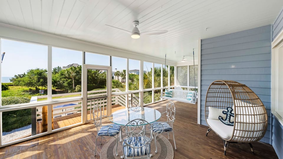 Coastal breezes and morning coffee—your favorite spot is waiting on the screened porch.
