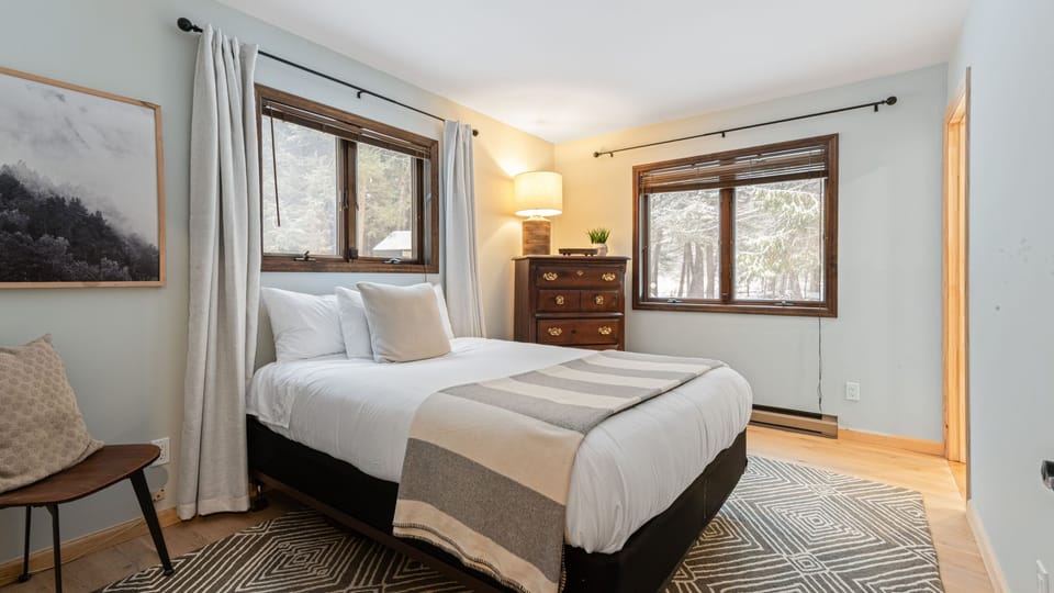 The primary bedroom features a queen bed and an ensuite bathroom.