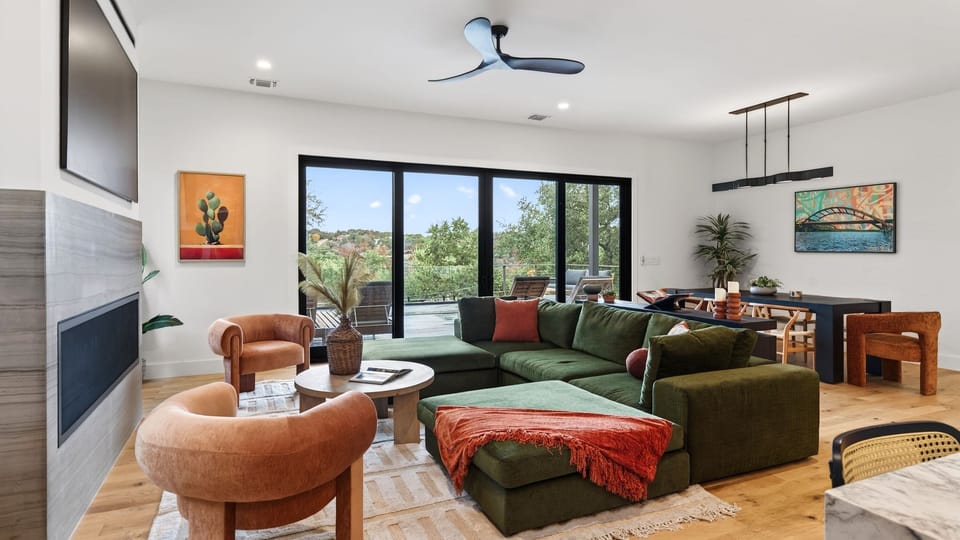 Sunlit living room with floor-to-ceiling sliders and seamless indoor–outdoor flow.