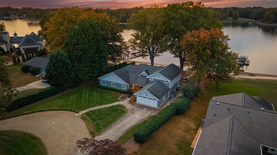 Aerial view of the neighborhood with the tranquil lake as the backdrop.