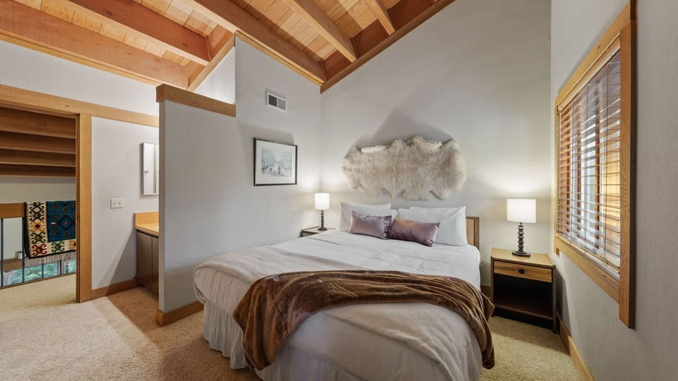 The primary bedroom features a king bed with a vanity nook.