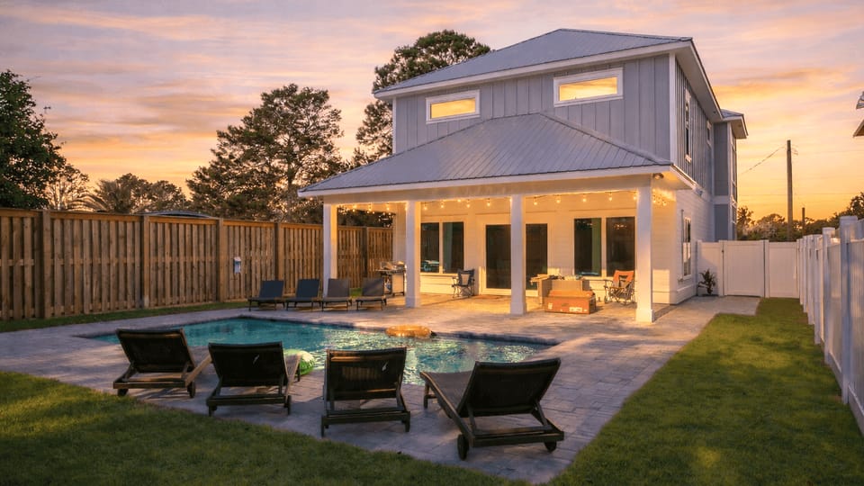 Modern two-story coastal home with a private pool and covered patio.