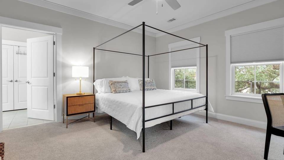 The primary bedroom features a king bed, TV, desk and an ensuite bathroom.