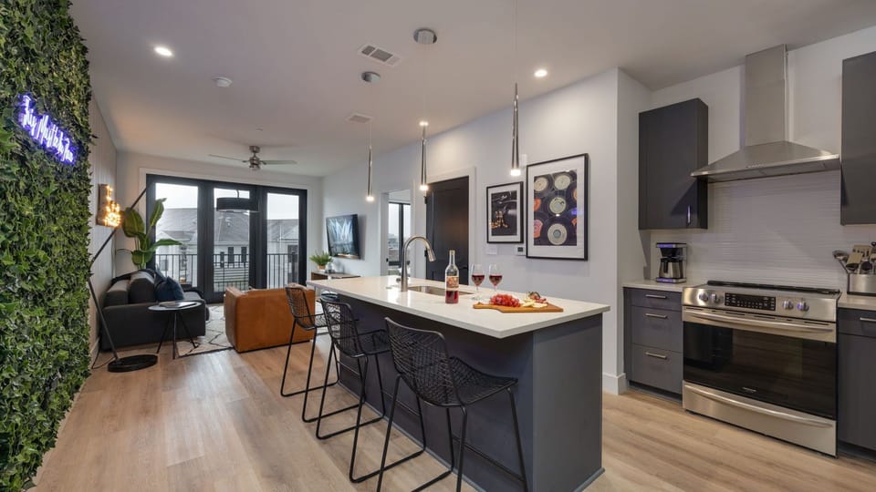 Open-concept layout showing the seamless transition from the kitchen island to the living area.