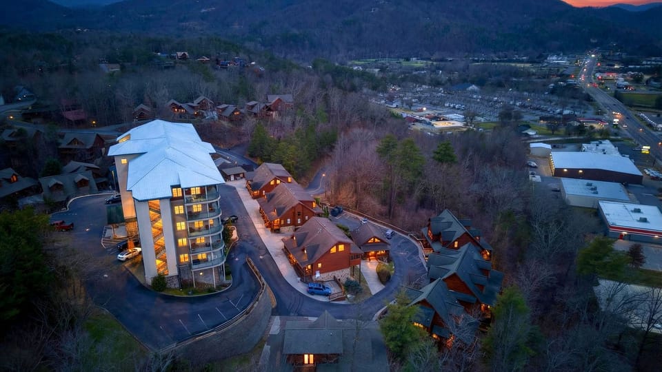 Aerial twilight view of the cabin resort nestled in the mountains.