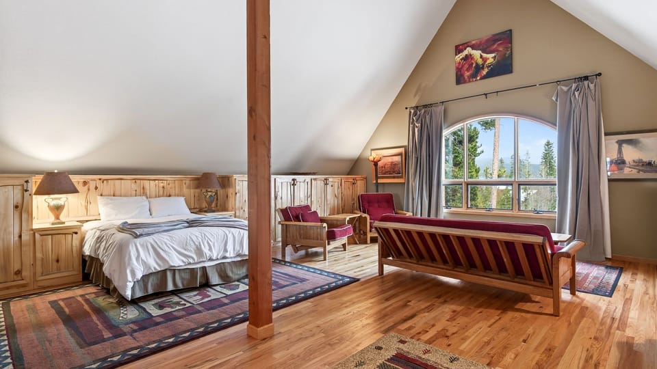 Bonus room featuring a queen bed with living space and a kitchenette.