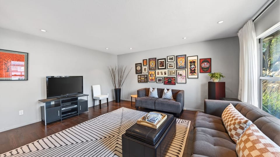 Comfortable living room with curated artwork—an inviting spot to unwind after a day of exploring.
