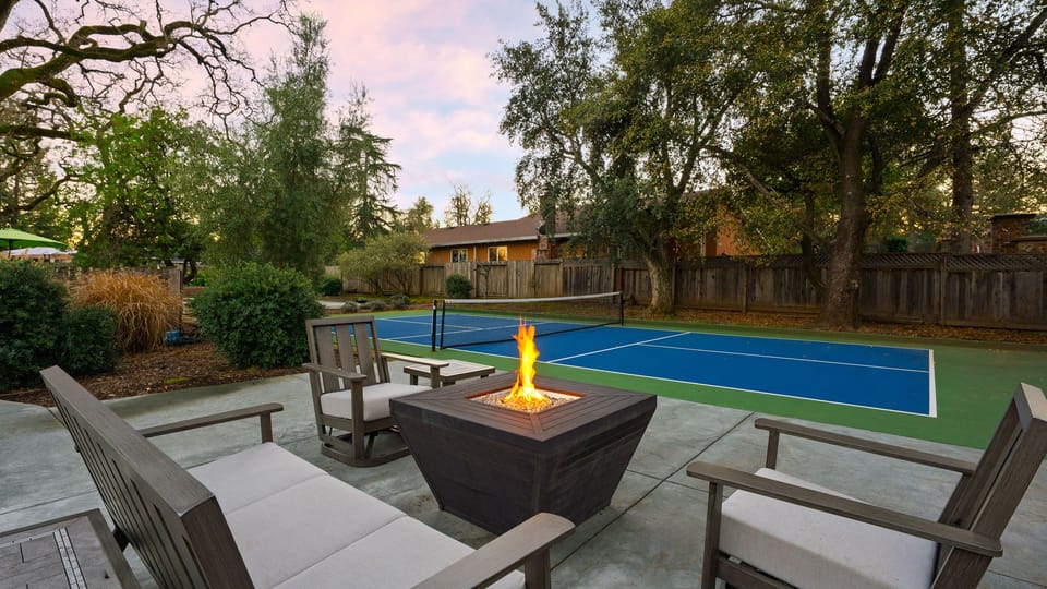 Evenings come alive around the fire pit, with a private pickleball court just steps away.
