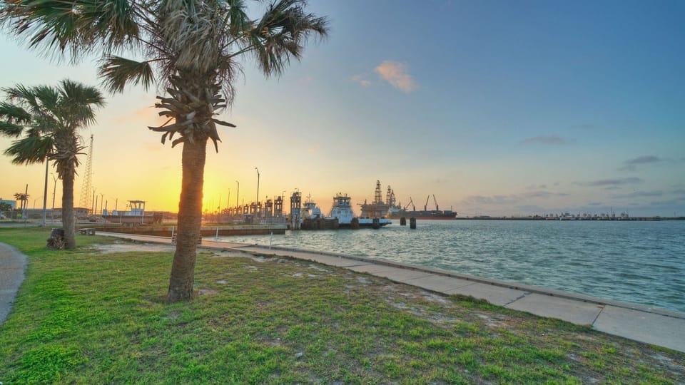 Sunset over the local harbor and industrial shipping area.